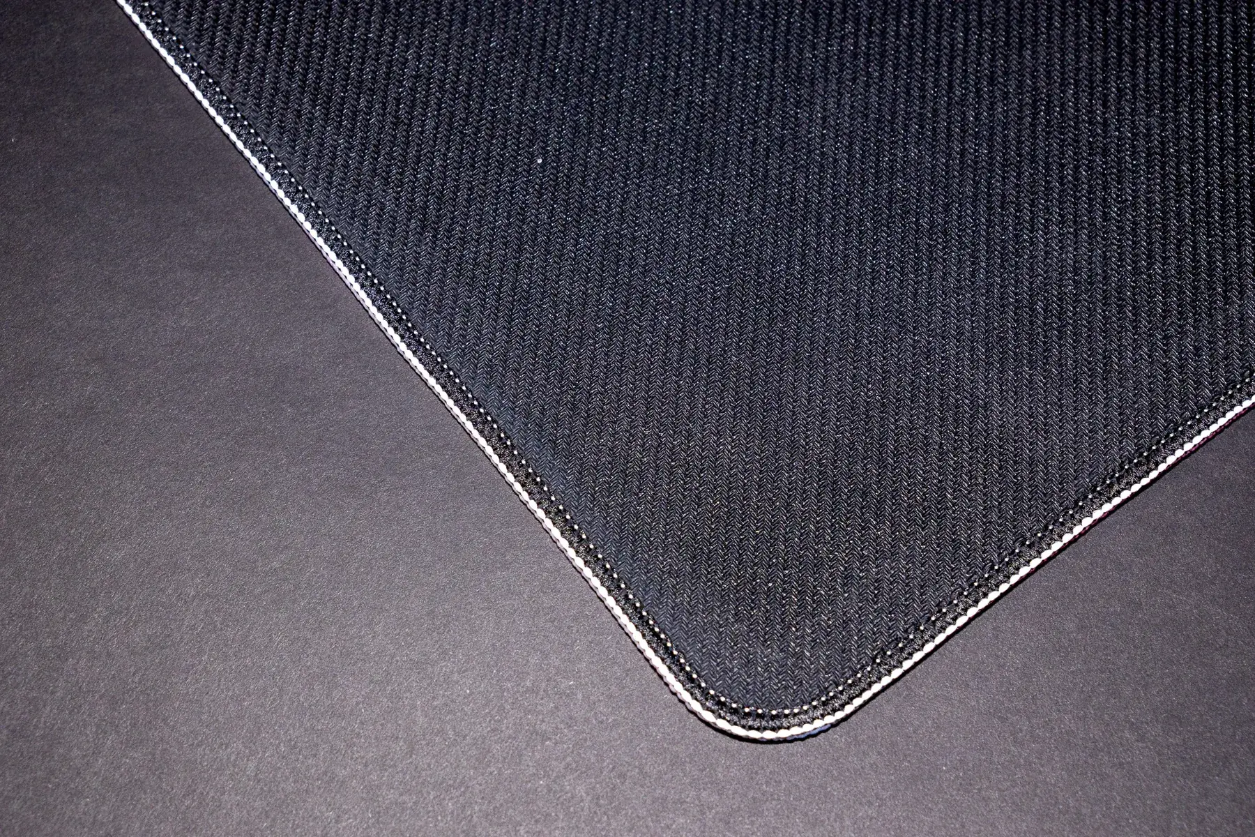 Machine-stitched edges and rubber base